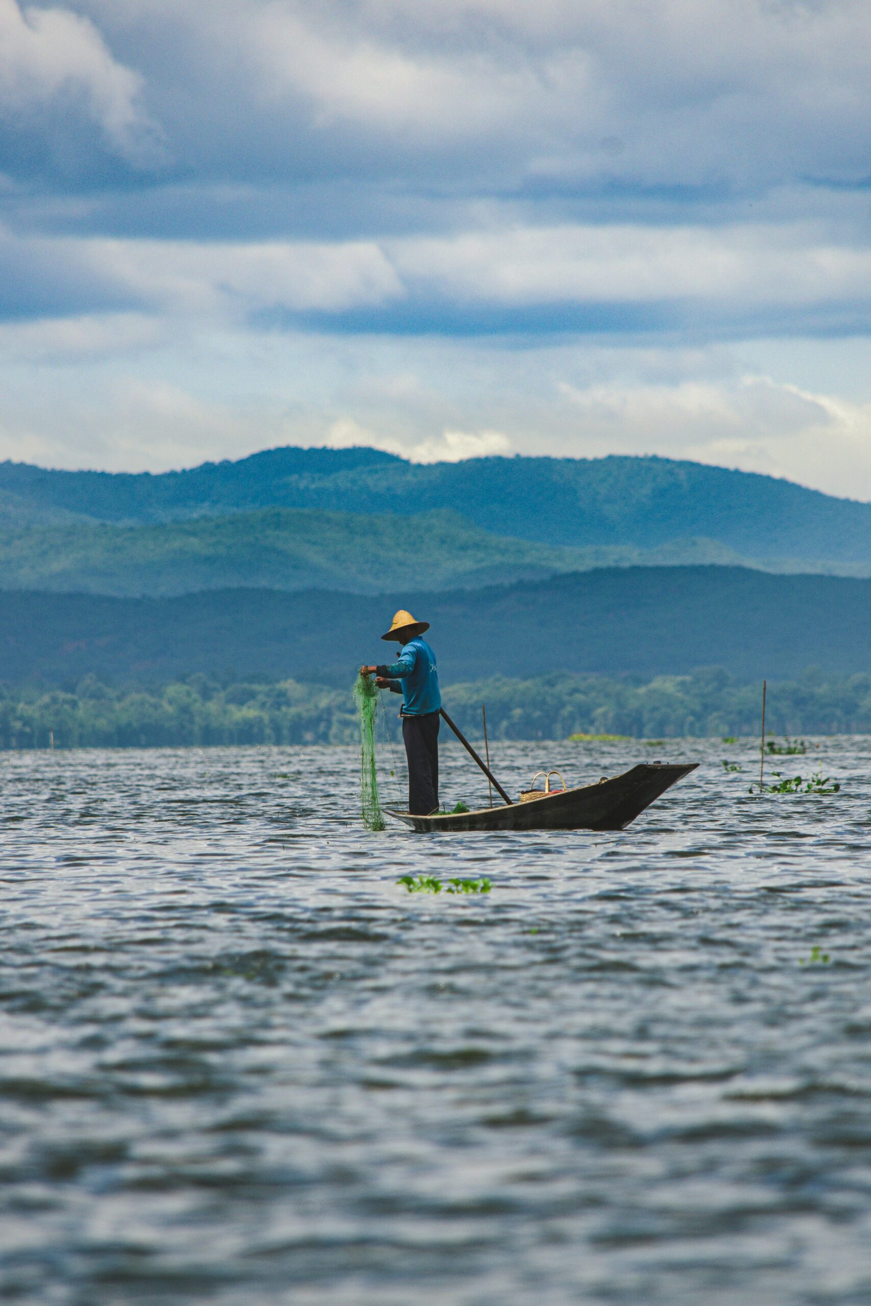 Pescadores em barcos ao pôr do sol